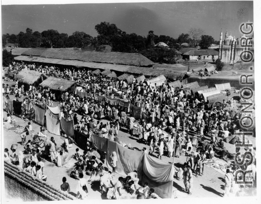 A busy market.  Scenes in India witnessed by American GIs during WWII. For many Americans of that era, with their limited experience traveling, the everyday sights and sounds overseas were new, intriguing, and photo worthy.