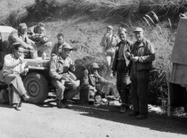 Advance detail on road from Gushkara to Chabua. American and Chinese soldiers stop for a meal over an open flame.