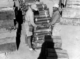 Chinese soldiers arrange equipment and munitions into 5000 lbs loads for air drop to Allied forces in Burma. 1944.