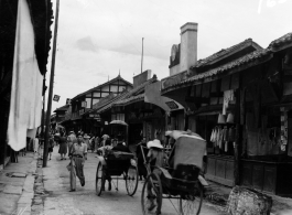 A pleasant market street in China, probably Kunming, during WWII.