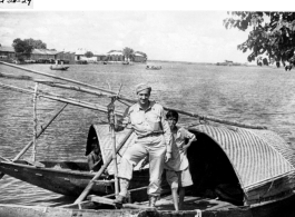 A GI in a boat with a young boat (who seems to be smoking) in Burma (or India) during WWII.  Image provided by Emery and Beth Vrana.