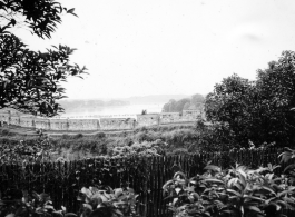 A protective wall, from the inside, with lake or river in the background. In China during WWII.