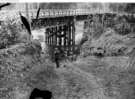 GIs bathe by American-made bridge in Burma (or India), during WWII.  Image provided by Emery and Beth Vrana.