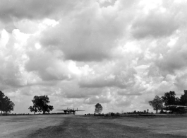 An American B-25 bomber at Yangkai, Yunnan province, in motion, while another is parked to the right. During WWII.