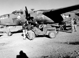 Early morning at Yankai Air Base, China. Aircrew, in flight jackets, and maintenance personnel of the the 491st Bomb Squadron prepare for a mission.  This is probably a newly arrived aircraft, because the B-25D, no mission symbols are displayed below the pilot\'s window.  Photo was probably taken in the spring of 1944.