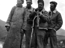 GIs pose with Chinese man and try out his long pipe. During WWII.