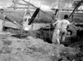 12th Air Service Group mechanics salvage a P-51 fighter in Guangxi, China, during WWII.