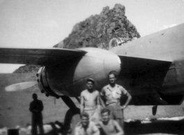 12th Air Service Group men pose in revetment with B-25 in Guangxi, before a karst peak. During WWII.