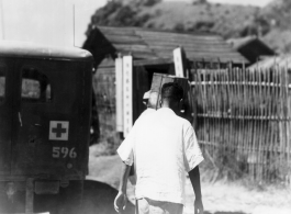 A medical orderly walks by an ambulance in Guangxi province, China, during WWII.