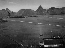 Photos taken by Robert F. Riese in or around Liuzhou city, Guangxi province, China, in 1945.  Aerial view adjacent to the American base at Liuzhou. Notice the shadow the airplane in the foreground.