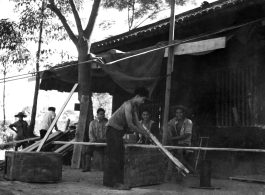 A carpenter rips lumber by hand saw in Liuzhou, China, during WWII.