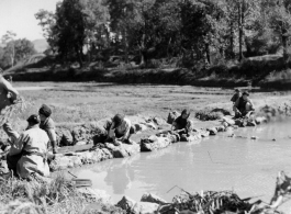 Local people wash clothes. Probably at Yangkai, China. During WWII.