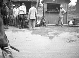 Some commotion around man on ground on street in Yunnan, during WWII.