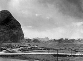 Tents for GIs at the American base at Liuzhou during WWII. Not the man fishing in the lower right, and the volleyball court right below the tents in the middle.