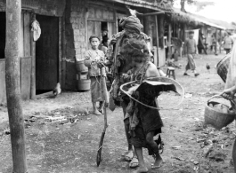 Local people in Yunnan province, China: Two of the village's destitute walking down the road.