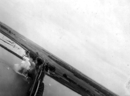 An aerial photograph of a bridge being bombed by the 491st Bomb Squadron in Yunnan or Indochina, during WWII.