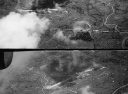 Aerial view of bombing of air base, likely in Burma. During WWII.