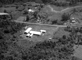 Aerial view of tidy structures on the ground in Burma or French Indochina, in the CBI, during WWII.