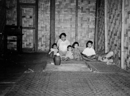 Local people in Burma near the 797th Engineer Forestry Company--A woman with children in a home in Burma.  During WWII.