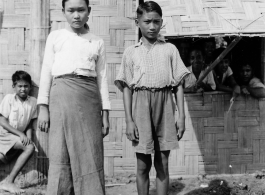 Local people in Burma near the 797th Engineer Forestry Company--girl and boy, apparently stand in front of missionary school.  During WWII.