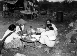 Local people in Burma near the 797th Engineer Forestry Company--Ladies chat over food and drink at a market in Burma.  During WWII.