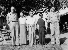 Local people in Burma near the 797th Engineer Forestry Company--GIs pose with man and two women in Burma.  During WWII.