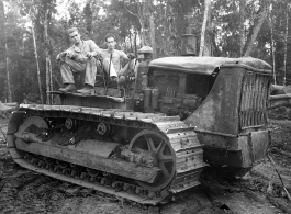 GIs pose on bulldozer in Burma.  797th Engineer Forestry Company in Burma.  During WWII.