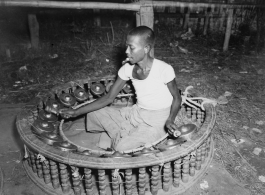 Local people in Burma near the 797th Engineer Forestry Company--Man plays linkwin (cymbals) in Burma.  During WWII.