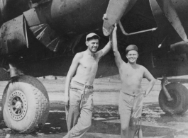 Men of 330th Troop Carrier, 9th CC, stand with C-46 transport.   The writing on the back of this picture indicates the person on the left is Dave Sobel, with Arnold Wall on the right (on different pictures gives a name Milt Sobel. However, Milt Sobel is closer in height to Arnold, and Milt also commonly has a cigarette in his left hand).   From the collection of Arnold Wall. (Much appreciation to son D. W.)