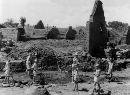 Chinese laborers working around destroyed houses, most likely in Yunnan province.