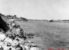 Bob Riese looks over a destroyed bridge at Liuzhou, China, during WWII, in 1945.