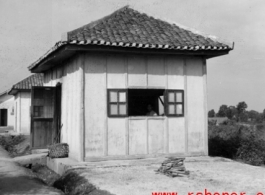 Several small buildings on a base in China during WWII.