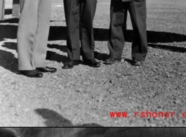 Chennault and Chinese officers pose and chat next to a B-25 Mitchell bomber in China during WWII.