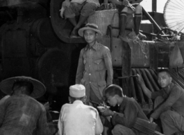 Chinese refugees take a meal in front of the train engine in Liuzhou during WWII, in the fall of 1944, as the Japanese advanced during the Ichigo campaign.