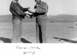 Col. Richard Wise (left) receives the prize--a spittoon "Piss-pot" at a horse race arranged at Guilin during WWII.