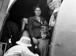 A civilian family of westerners on a military C-47 transport in the CBI during WWII, on June 8, 1944.