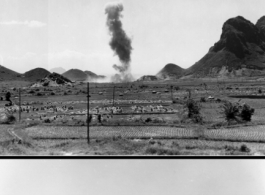 A P-40 fighter burns in the distance, October 9, 1944.  This is in Guangxi province, either Guilin or Liuzhou.