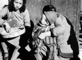 Local people in China go about their daily lives in China at roadside. During WWII.