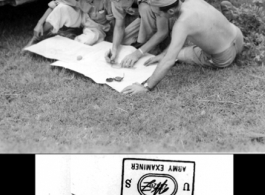 GIs looking at map next to their camouflaged jeep. In China during WWII.