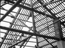 Trusses and structure for a large roof being built in China during WWII.