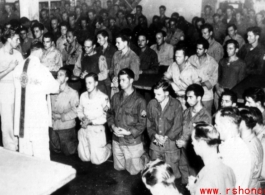 GIs have communion during church service on ship on the way back to the US after the war. The ship is probably the SS Marine Raven.