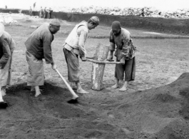 Chinese laborers working at an airbase somewhere in China.  Image from U. S. Government official sources.