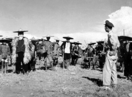 Workers in locally made hats and weather protection in China during WWII. These are most likely working on an American air base.  Official Gov. Image.