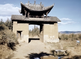 A decorative gate, strangely by itself, in the countryside somewhere in Yunnan province, China. During WWII.