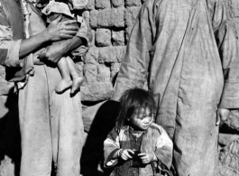 Local people in a village in China, probably in Yunnan province.  From the collection of Wozniak, combat photographer for the 491st Bomb Squadron, in the CBI.