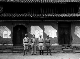 Chinese soldiers in the CBI stand before building with a slogan 整军经武 (roughly "build up the military")  in Yunnan province, China.