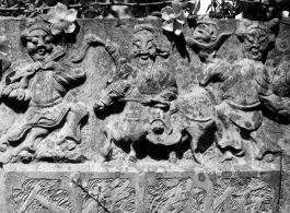 Carvings on a gravestone in Yunnan province, China.