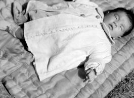 A sleeping baby in China during WWII, in Yunnan province.