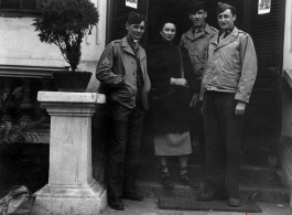An elite Chinese woman poses with American servicemen and local people in Yunnan province, China, during WWII. 