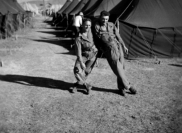 Scenes around Kunming city, Yunnan province, China, during WWII: GIs goof among tents at Kunming.